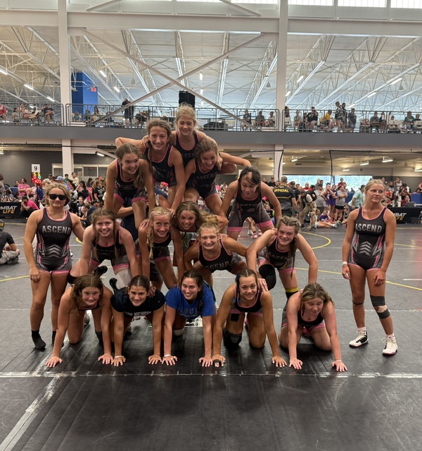 Ascend girls team building a human pyramid
