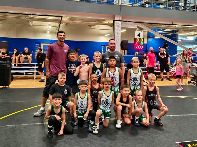 Ascend youth wrestlers with coaches at a competition